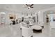 Bright, open-concept living space with white seating, and kitchen in the background at 4206 E Blue Ridge Pl, Chandler, AZ 85249