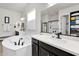 Bright main bathroom featuring a soaking tub with sleek black hardware and walk-in shower at 4206 E Blue Ridge Pl, Chandler, AZ 85249