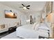 Beautiful main bedroom featuring dark hardwood floors, ceiling fan and flat screen television at 4206 E Blue Ridge Pl, Chandler, AZ 85249