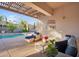 Inviting patio with comfortable seating, a pergola for shade, and a view of the pool's water feature at 4206 E Blue Ridge Pl, Chandler, AZ 85249