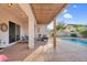Covered patio featuring lounge chairs, stylish decor, and an inviting view of the sparkling swimming pool at 4206 E Blue Ridge Pl, Chandler, AZ 85249