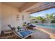 Relaxing outdoor patio with a covered pergola, lounge chairs, and a view of the sparkling pool at 4206 E Blue Ridge Pl, Chandler, AZ 85249