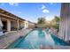 Inviting pool area with a covered patio, rock waterfalls, and ample space for lounging and relaxation at 4206 E Blue Ridge Pl, Chandler, AZ 85249
