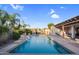 Beautiful pool area with rock waterfalls and lush tropical landscaping creating a serene backyard oasis at 4206 E Blue Ridge Pl, Chandler, AZ 85249
