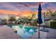 Backyard pool with waterfalls, lush landscaping, and resort-style umbrellas for shade at 4206 E Blue Ridge Pl, Chandler, AZ 85249