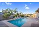 A backyard pool with waterfall features is surrounded by lush landscaping at 4206 E Blue Ridge Pl, Chandler, AZ 85249