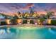 Backyard pool with waterfall features, lush landscaping, and brick perimeter at 4206 E Blue Ridge Pl, Chandler, AZ 85249