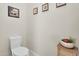 This powder room has earth tone wall art, a toilet and small wicker table at 4206 E Blue Ridge Pl, Chandler, AZ 85249