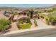 A beautiful home with solar panels, a lush front lawn, and desert landscaping at 4418 W Yoosooni Dr, New River, AZ 85087