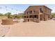 Expansive backyard featuring an outdoor kitchen, firepit, lush landscaping, and a sparkling swimming pool at 4418 W Yoosooni Dr, New River, AZ 85087