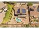 Aerial view of a landscaped backyard with a custom pool, a covered patio, and a fire pit at 4418 W Yoosooni Dr, New River, AZ 85087