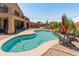 Beautiful backyard featuring a sparkling pool with a waterfall feature and adjacent lounge seating at 4418 W Yoosooni Dr, New River, AZ 85087