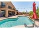 Stunning backyard featuring a pool, water feature, outdoor bar and covered patio with furniture at 4418 W Yoosooni Dr, New River, AZ 85087