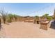 Entertainer's backyard with a custom outdoor kitchen, firepit, and landscaped patio, perfect for gatherings at 4418 W Yoosooni Dr, New River, AZ 85087