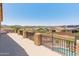 Balcony view showcasing beautiful desert landscape with mountain views, a pool, and an outdoor fireplace at 4418 W Yoosooni Dr, New River, AZ 85087