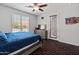 A modern bedroom featuring wood-look floors and a door leading outside at 4418 W Yoosooni Dr, New River, AZ 85087