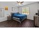 A modern bedroom featuring a ceiling fan and a window with views of the outdoors at 4418 W Yoosooni Dr, New River, AZ 85087