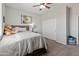 Bright bedroom with a ceiling fan, a comfortable bed, and a closet at 4418 W Yoosooni Dr, New River, AZ 85087