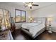 Cozy bedroom with a king bed, shutters, and decorative mirror at 4418 W Yoosooni Dr, New River, AZ 85087
