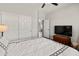 Light-filled bedroom with a double door closet, ceiling fan, and dark floors at 4418 W Yoosooni Dr, New River, AZ 85087