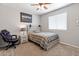 Bright bedroom with a ceiling fan, a comfortable bed, and a window with blinds at 4418 W Yoosooni Dr, New River, AZ 85087