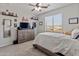 Cozy bedroom featuring a dresser, ceiling fan, and a view of the outdoors at 4418 W Yoosooni Dr, New River, AZ 85087