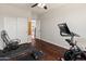 Exercise room featuring a peloton, rocking chair, and wood-look floors at 4418 W Yoosooni Dr, New River, AZ 85087