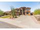 Spacious two-story home featuring desert landscaping, a three car garage and an American flag at 4418 W Yoosooni Dr, New River, AZ 85087