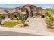 A well-maintained two-story home with desert landscaping and an American flag at 4418 W Yoosooni Dr, New River, AZ 85087