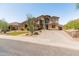 Spacious two-story home featuring desert landscaping, a three car garage and an American flag at 4418 W Yoosooni Dr, New River, AZ 85087