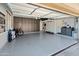 Spacious garage with epoxy flooring, ample storage cabinets, and organizational system at 4418 W Yoosooni Dr, New River, AZ 85087