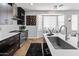 Stylish kitchen featuring dark cabinets, stainless steel appliances, and quartz countertops at 4418 W Yoosooni Dr, New River, AZ 85087