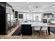 Open-concept kitchen with stainless appliances, a large island, and a modern lighting fixture at 4418 W Yoosooni Dr, New River, AZ 85087