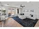 An open living room featuring a comfortable white couch and direct access to the backyard at 4418 W Yoosooni Dr, New River, AZ 85087