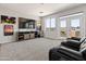 Comfortable living room featuring a ceiling fan, large windows, and walkout at 4418 W Yoosooni Dr, New River, AZ 85087