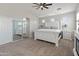 A comfortable main bedroom features a large bed and ensuite bathroom at 4418 W Yoosooni Dr, New River, AZ 85087
