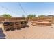 Spacious outdoor kitchen area with grill, bar seating, and a cozy firepit, great for hosting gatherings at 4418 W Yoosooni Dr, New River, AZ 85087