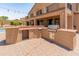Outdoor kitchen with stainless steel grill and prep area, set on a brick patio, ideal for barbecues at 4418 W Yoosooni Dr, New River, AZ 85087