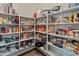 Well-organized pantry featuring ample shelving filled with an array of food items and kitchen appliances at 4418 W Yoosooni Dr, New River, AZ 85087