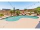 Inviting backyard pool with rock waterfall feature, desert landscaping, and lounge chairs, perfect for relaxation at 4418 W Yoosooni Dr, New River, AZ 85087