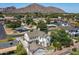 Panoramic aerial view of the property showcases landscaping, neighborhood, and mountain backdrop at 4901 E Amelia Ave, Phoenix, AZ 85018