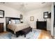 Serene bedroom with a king-size bed, dark wood furniture, and stylish decor at 4901 E Amelia Ave, Phoenix, AZ 85018