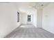 Bright bedroom featuring a ceiling fan, carpet flooring, and a window with black trim at 4901 E Amelia Ave, Phoenix, AZ 85018
