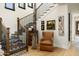 Elegant foyer with wooden staircase, hardwood floors, and decorative art at 4901 E Amelia Ave, Phoenix, AZ 85018