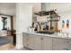 Open-concept kitchen with stone countertops and stainless steel exhaust hood at 4901 E Amelia Ave, Phoenix, AZ 85018