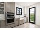 Bright kitchen features stainless steel appliances, apron sink, and a black-framed window at 4901 E Amelia Ave, Phoenix, AZ 85018