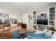 Open-concept living area with hardwood floors, built-in bookcases, and an open flow to the kitchen at 4901 E Amelia Ave, Phoenix, AZ 85018