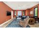 Stylish living room with a leather sectional, a modern rug, and a flat-screen TV at 4901 E Amelia Ave, Phoenix, AZ 85018