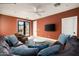 Comfortable living room with a large sectional sofa, a ceiling fan, and a TV at 4901 E Amelia Ave, Phoenix, AZ 85018