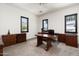 Office with carpet, traditional wood furniture, and three windows providing plenty of light at 4901 E Amelia Ave, Phoenix, AZ 85018
